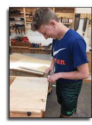 Declan using shoulder plane to fit corner joinery of the box.